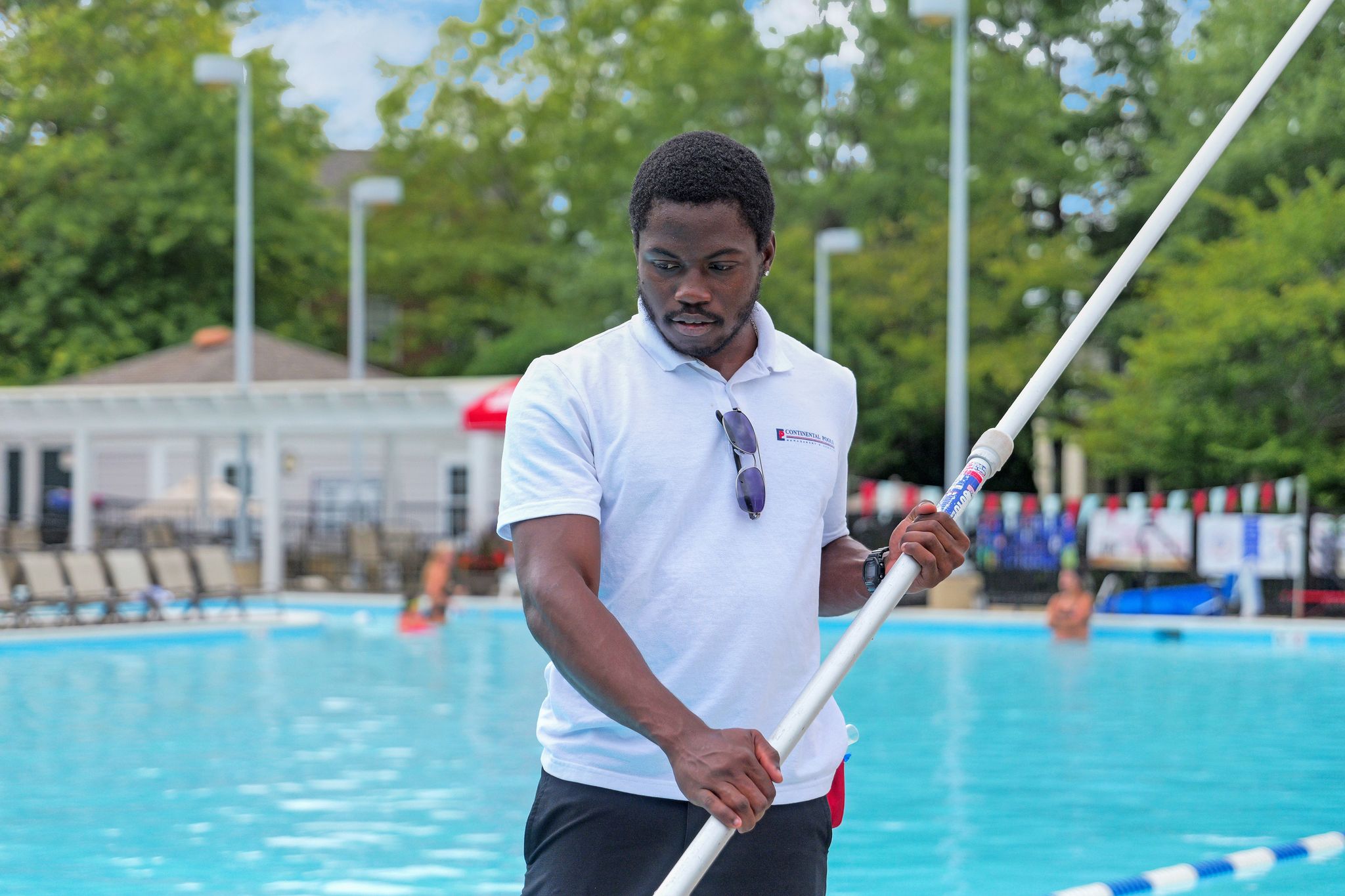 Pool technician cleaning the pool.